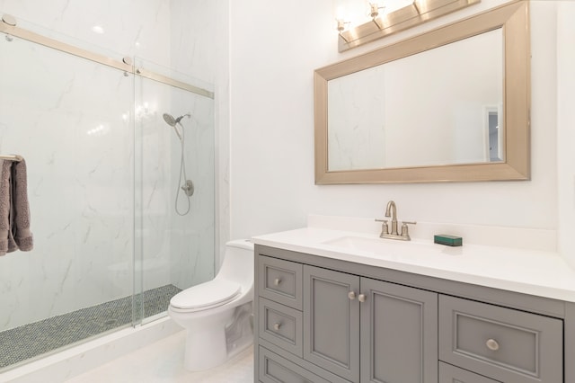 bathroom featuring vanity, toilet, and a shower with door