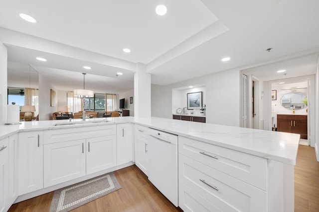 kitchen featuring white cabinetry, sink, light hardwood / wood-style flooring, kitchen peninsula, and white dishwasher