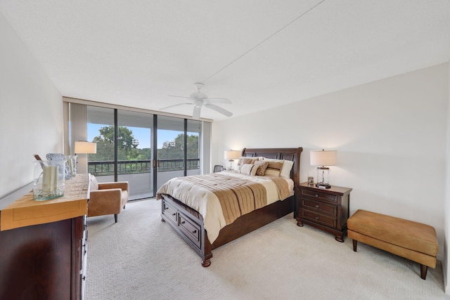 bedroom with access to exterior, ceiling fan, expansive windows, and light colored carpet