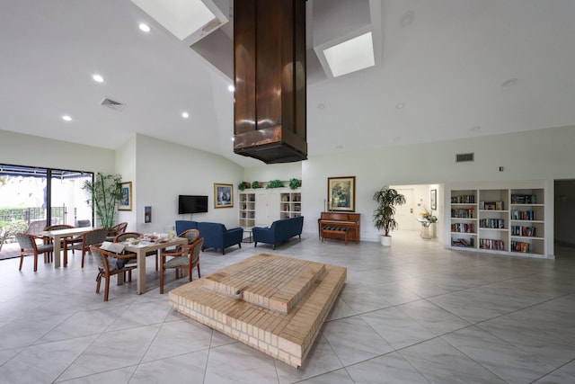 living room featuring built in shelves and high vaulted ceiling