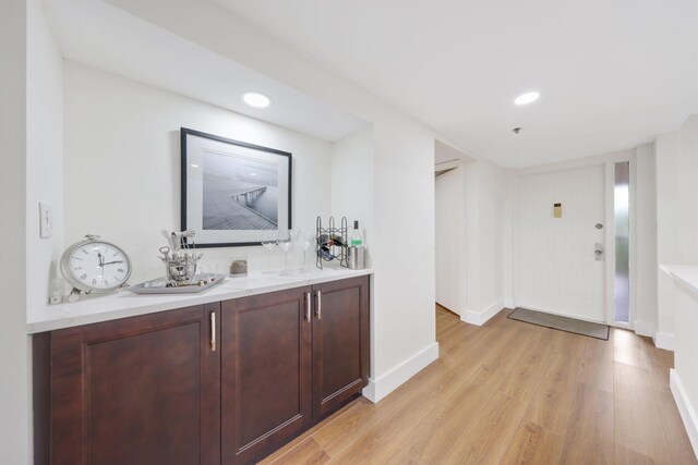 bar with light hardwood / wood-style floors