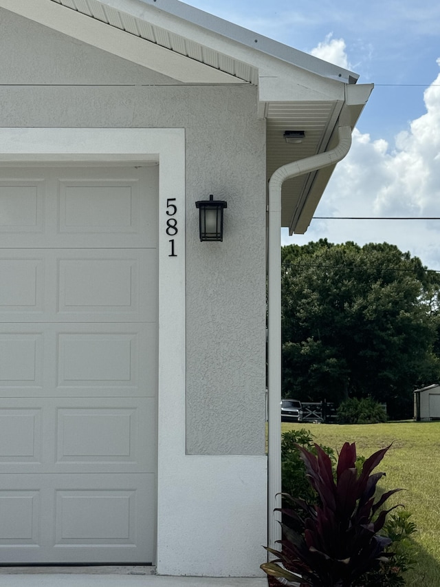 view of exterior entry featuring a lawn