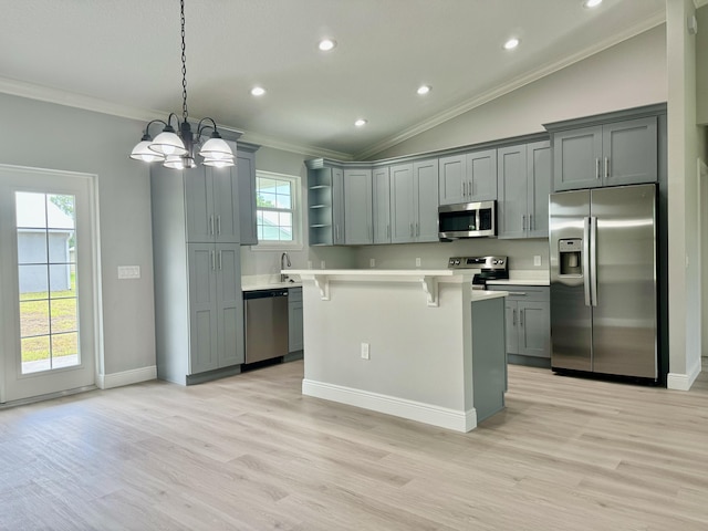 kitchen with gray cabinets, plenty of natural light, stainless steel appliances, and vaulted ceiling