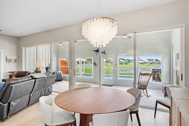 dining space featuring light hardwood / wood-style floors and an inviting chandelier