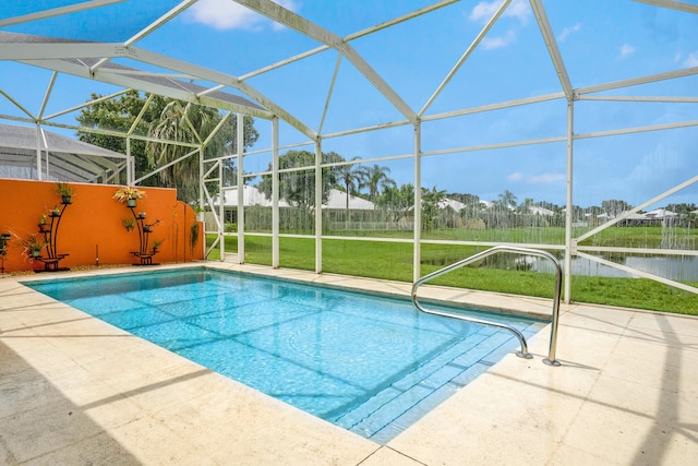 view of pool with glass enclosure, a patio area, and a lawn