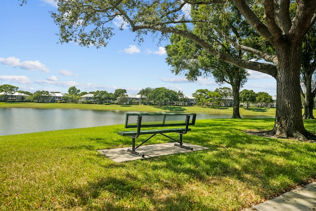 surrounding community featuring a water view and a yard