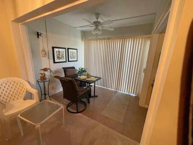 living area featuring tile patterned floors and ceiling fan