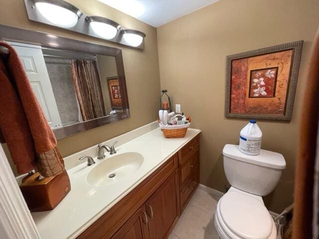 bathroom featuring tile patterned floors, vanity, and toilet