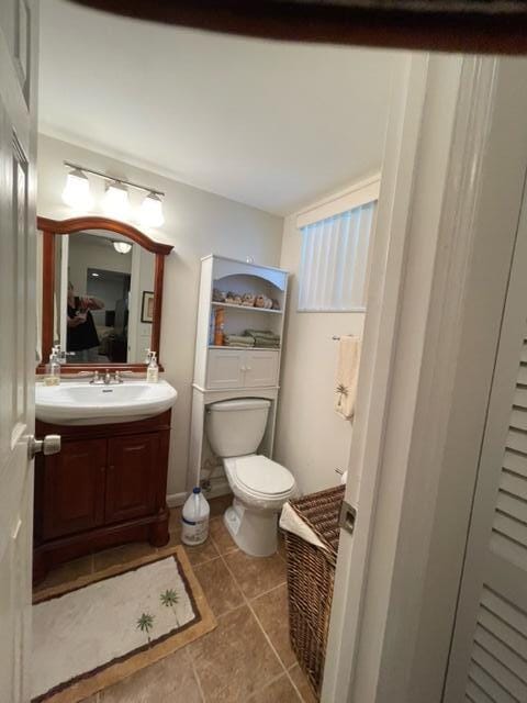 bathroom with tile patterned floors, vanity, and toilet