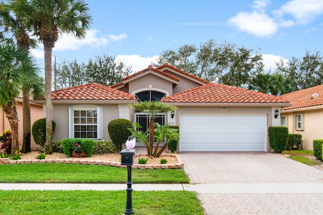 mediterranean / spanish-style home with a garage