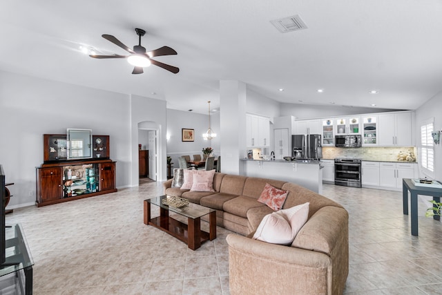 tiled living room featuring vaulted ceiling and ceiling fan