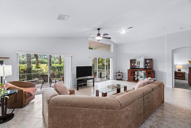 living room featuring high vaulted ceiling, ceiling fan, and light tile patterned flooring