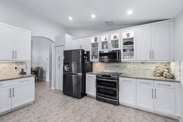 kitchen featuring white cabinetry, stainless steel appliances, and vaulted ceiling