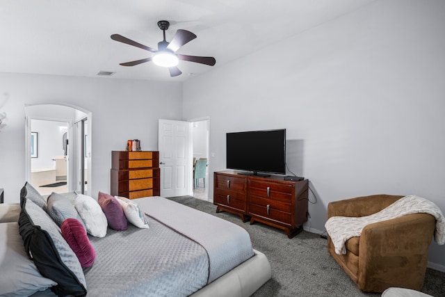 bedroom with ceiling fan, ensuite bathroom, lofted ceiling, and light carpet