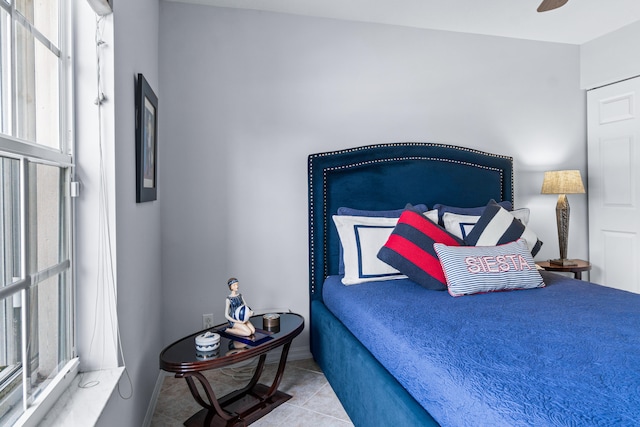 tiled bedroom with ceiling fan