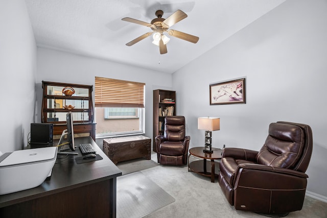 office area featuring ceiling fan, lofted ceiling, and light carpet