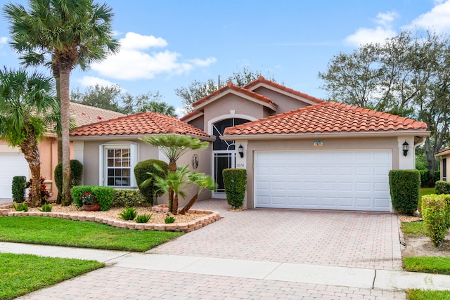 mediterranean / spanish home featuring a garage