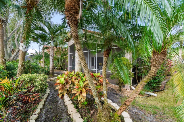 view of side of home featuring a sunroom