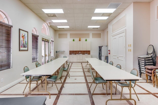 dining space with a paneled ceiling