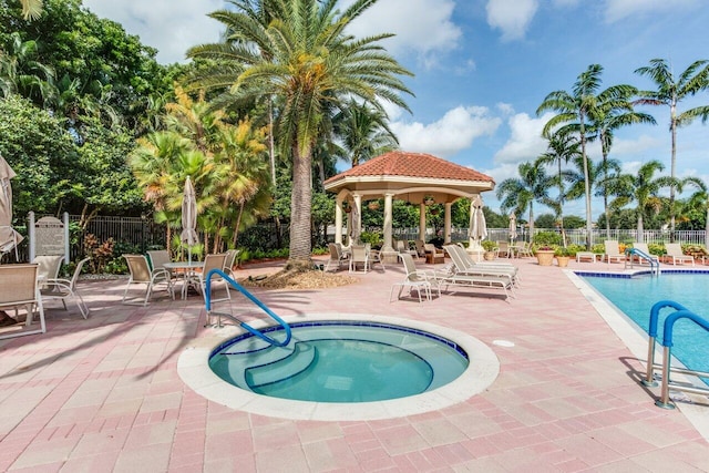 view of swimming pool with a patio and a hot tub