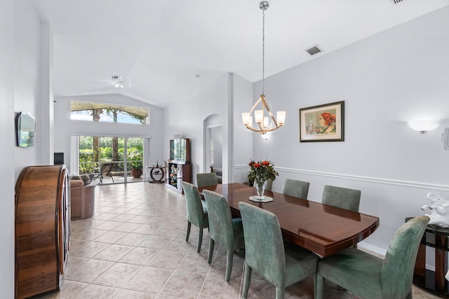 tiled dining room featuring a notable chandelier and high vaulted ceiling