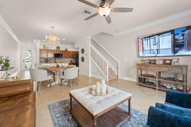 living room featuring ceiling fan with notable chandelier, light tile patterned floors, and ornamental molding