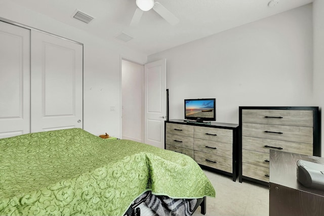 bedroom with ceiling fan and a closet