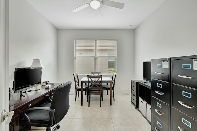 tiled home office featuring ceiling fan