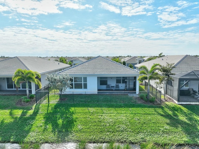 rear view of property featuring a yard