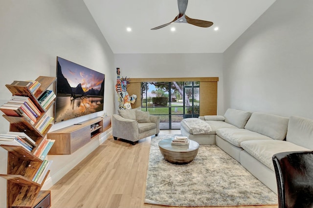 living room with ceiling fan, high vaulted ceiling, and light hardwood / wood-style floors