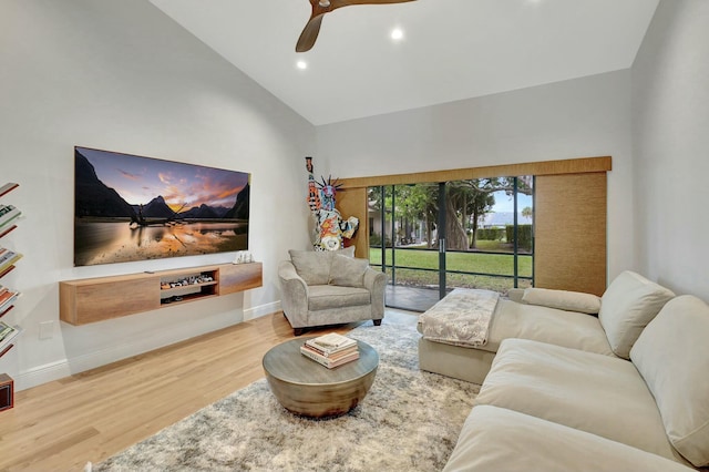 living room with hardwood / wood-style flooring, high vaulted ceiling, and ceiling fan