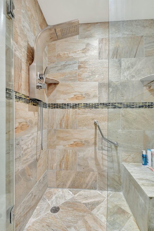 bathroom with a tile shower