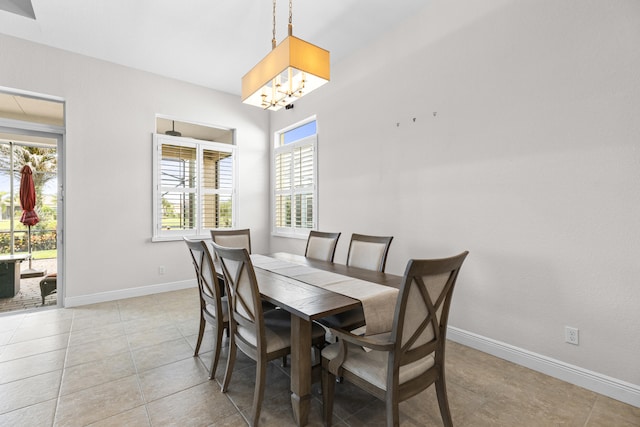 dining room featuring light tile patterned floors and an inviting chandelier