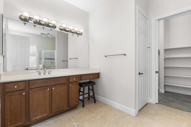 bathroom with tile patterned flooring, vanity, and a shower with shower door