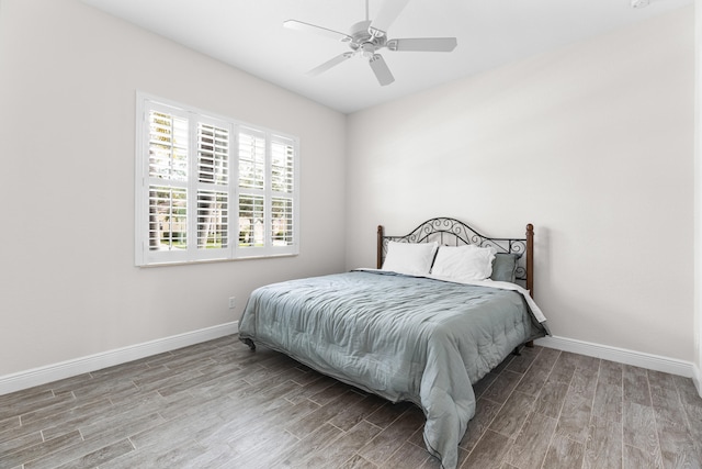 bedroom with hardwood / wood-style flooring and ceiling fan