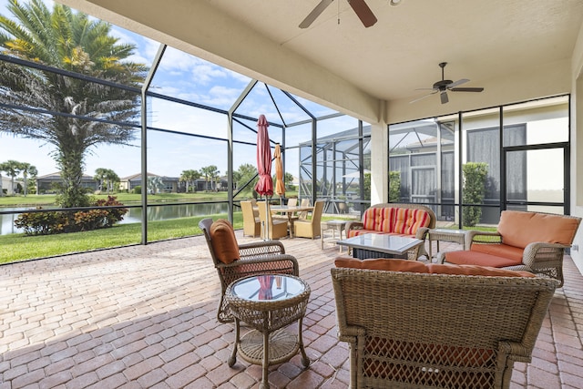 sunroom / solarium featuring a water view and ceiling fan