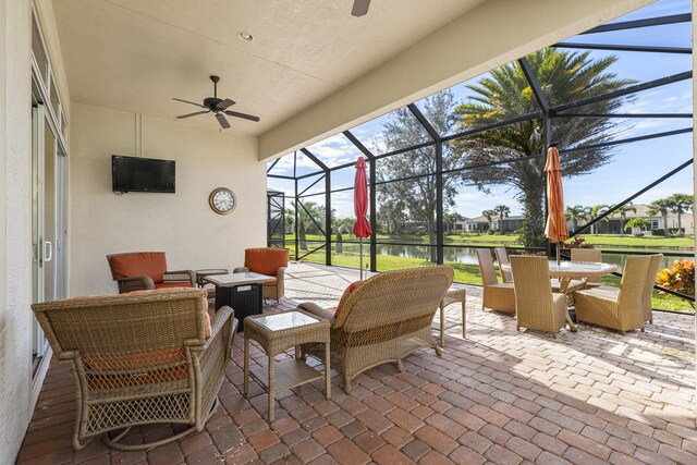 view of patio with outdoor lounge area, ceiling fan, and a lanai