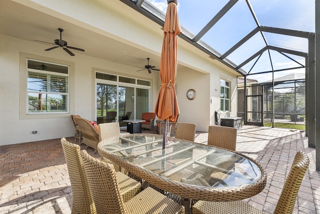 view of patio / terrace with ceiling fan and a lanai