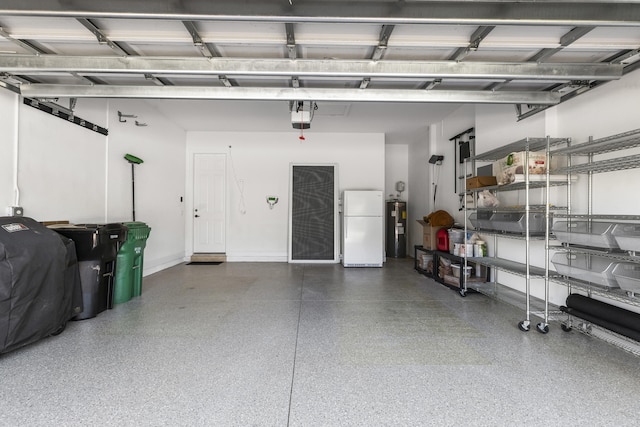 garage featuring electric water heater, a garage door opener, and white refrigerator