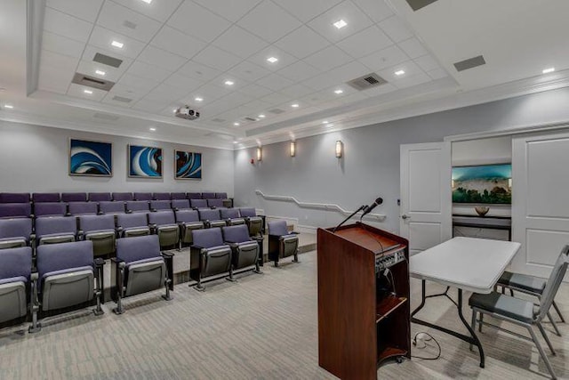 carpeted home theater room featuring a raised ceiling and crown molding