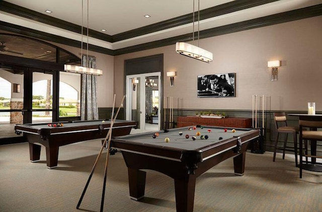 recreation room featuring carpet, ornamental molding, pool table, and a tray ceiling