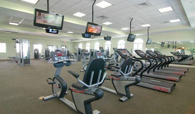 gym featuring plenty of natural light and a drop ceiling