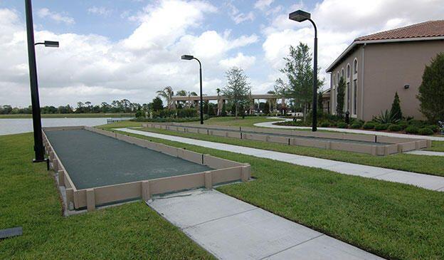 view of property's community with a lawn and a water view