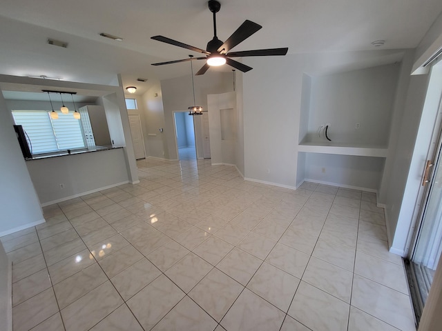 spare room with ceiling fan and light tile patterned floors