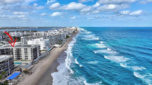 birds eye view of property with a beach view and a water view