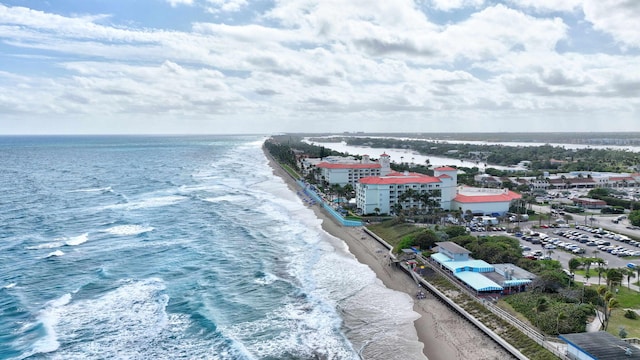 drone / aerial view with a water view and a view of the beach