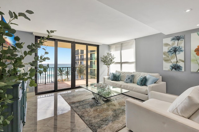 living room featuring floor to ceiling windows, french doors, and a water view