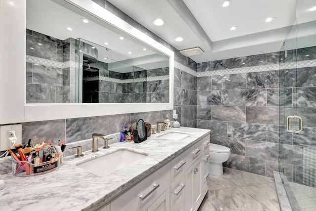 bathroom with vanity, toilet, walk in shower, and tile walls