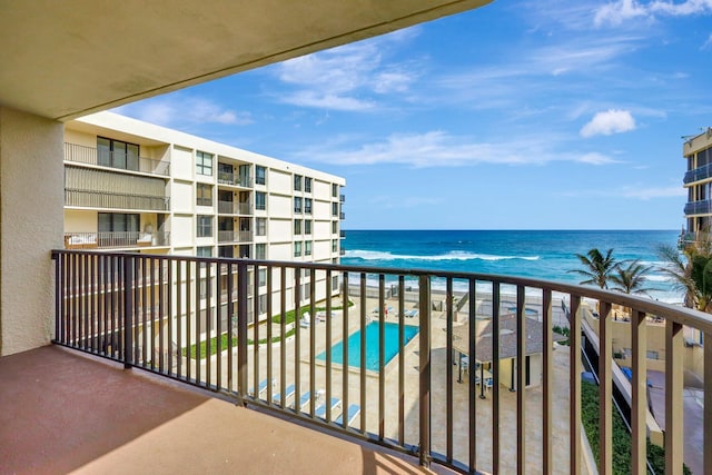 balcony featuring a water view and a view of the beach