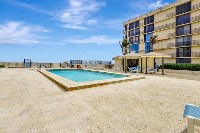 view of swimming pool with a patio